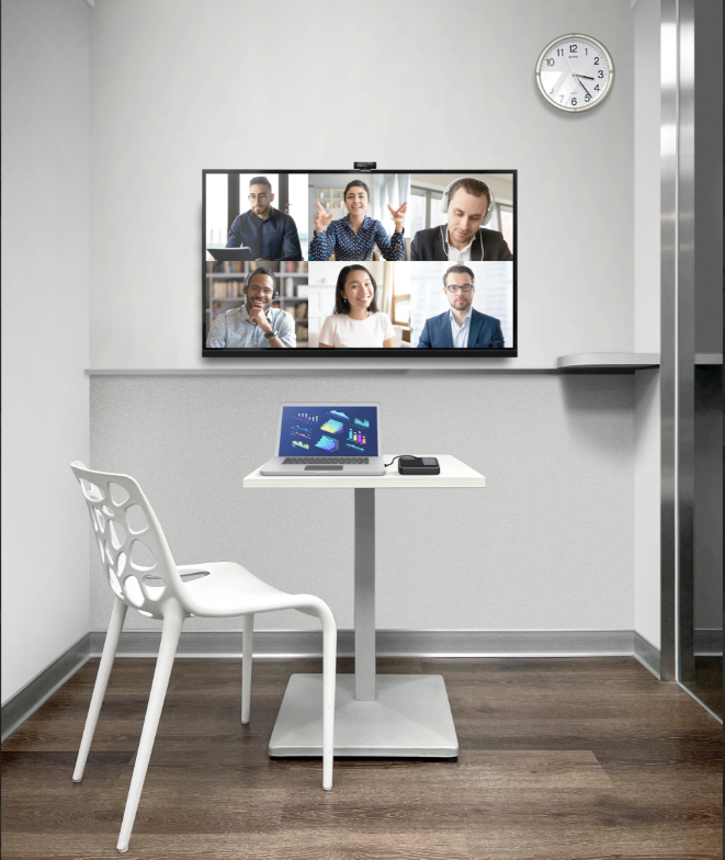 A high-quality webcam with a built-in microphone or a speakerphone is ideal for small room setups.