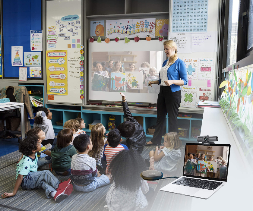 A teacher holding an intra-district online collaboration session with AVerMedia PW515 webcam and AS315 speakerphone. Both devices are plug-and-play, requiring no complex installations or setup time, simplifying the transition to online lessons.